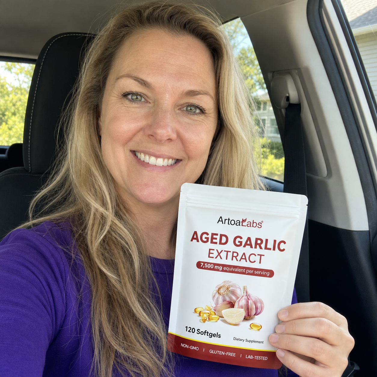 ArtoaLabs customer smiling in a car holding aged garlic extract